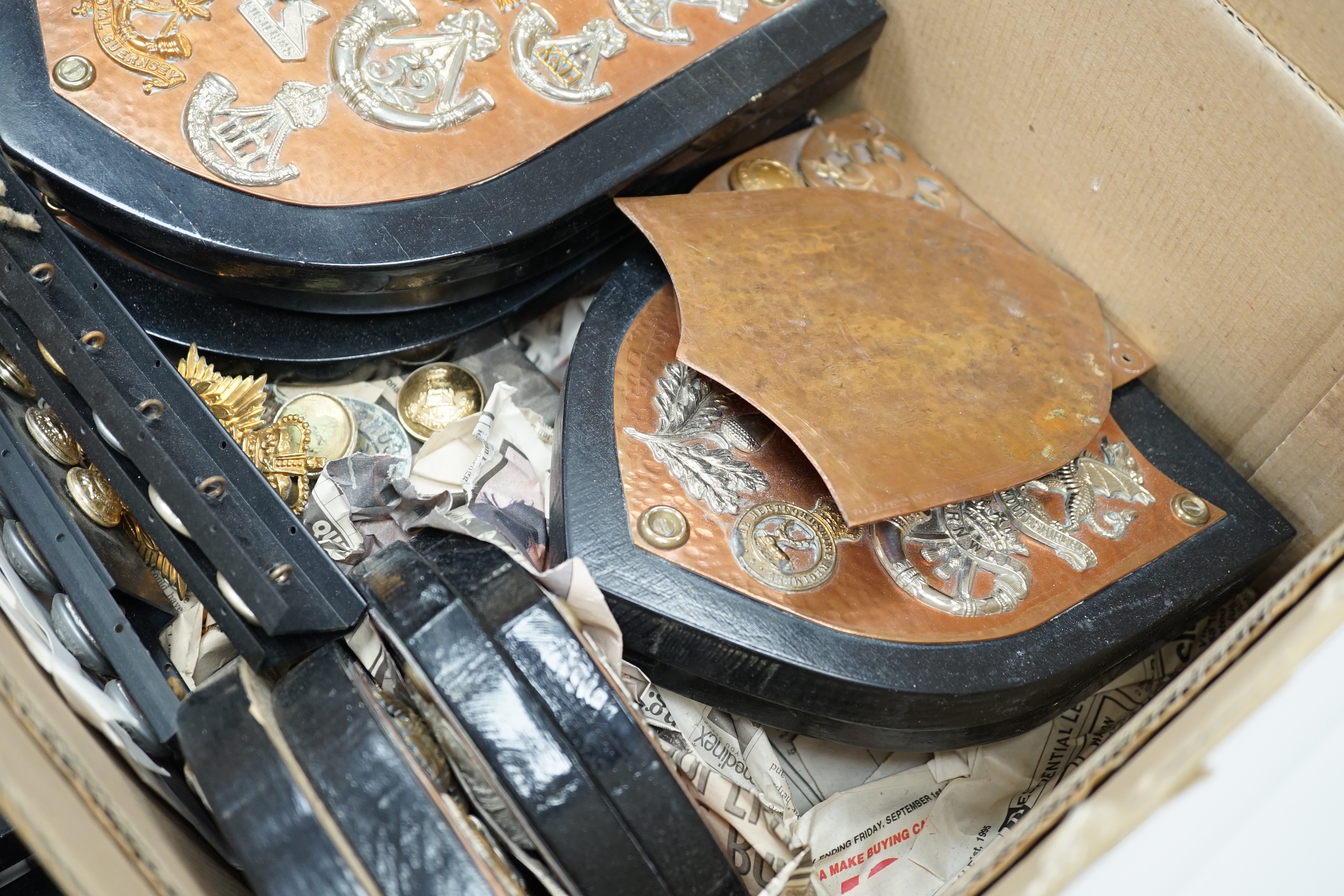 A collection of Military cap badges and buttons